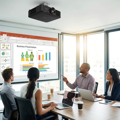 A photorealistic image showing the Epson PowerLite L615U laser projector ceiling-mounted in a modern conference room. A group of four professionals are engaged in a presentation projected onto a screen, with natural light filling the room.