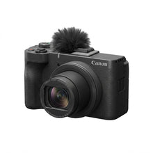 A crisp, front three-quarter view hero shot of the black Canon PowerShot V10 vlogging camera with its furry wind screen.