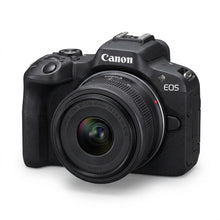 Black Canon EOS R50 mirrorless camera with an RF-S 18-45mm kit lens, shown at a three-quarter front angle on a white background.