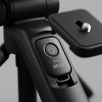 Macro photograph focusing on the integrated controls and premium textured handle of the Canon HG-100TBR Tripod Grip.