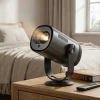 Dangbei Freedo portable projector sits on a modern bedroom nightstand with warm natural light.