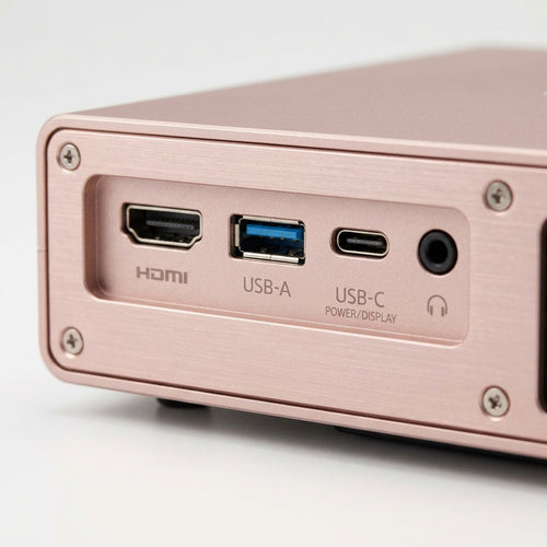A macro photo of the rose-gold Epson projector's detailed rear I/O panel, showcasing physical ports and connections.