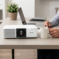 A photo of the Epson PowerLite L500W projector next to a standard coffee mug to show its true size.