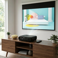 A black Epson projector projects onto a large screen in a modern living room setting.