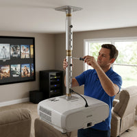 A lifestyle photograph of the Epson adjustable extension column installed between a ceiling plate and a projector.