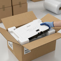 Ecommerce scene: Unboxing the Epson PowerLite 1780W projector from protective, form-fitting internal void-fill packaging.