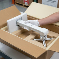 Unboxed Epson wall mount (MPN: V12HA06A05), protected by protective foam and a generic box.