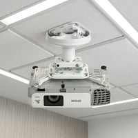 A white Epson projector with universal mount is attached to a textured office ceiling.