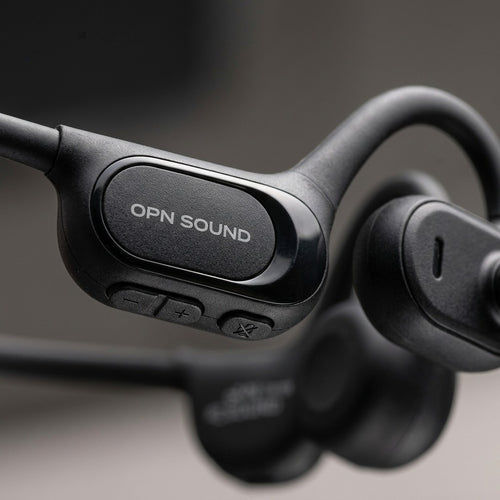 Macro close-up of OPN Sound Chat Pro: detailed textures of control pod, buttons, and directional audio.