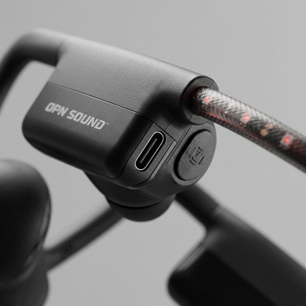 Macro view of OPN Sound Dashlyte+, highlighting USB-C port, power button, and text print.