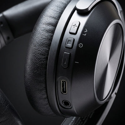 A detailed macro photograph showing the precise control interface and input panel on the SHARP HP-60 headphone earcup.